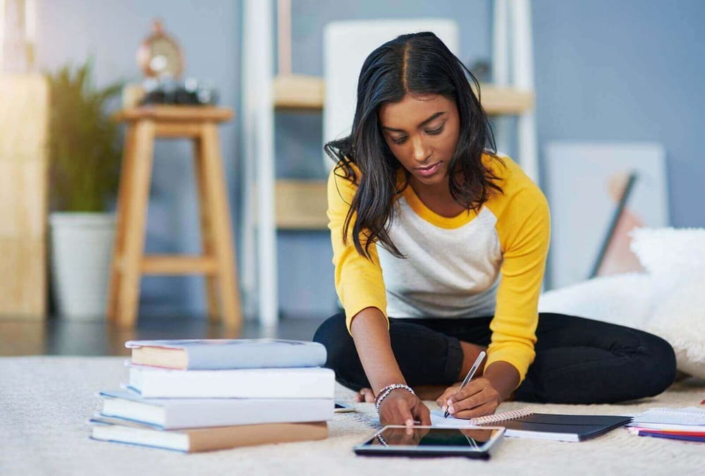 Shot of a young female student studying at home